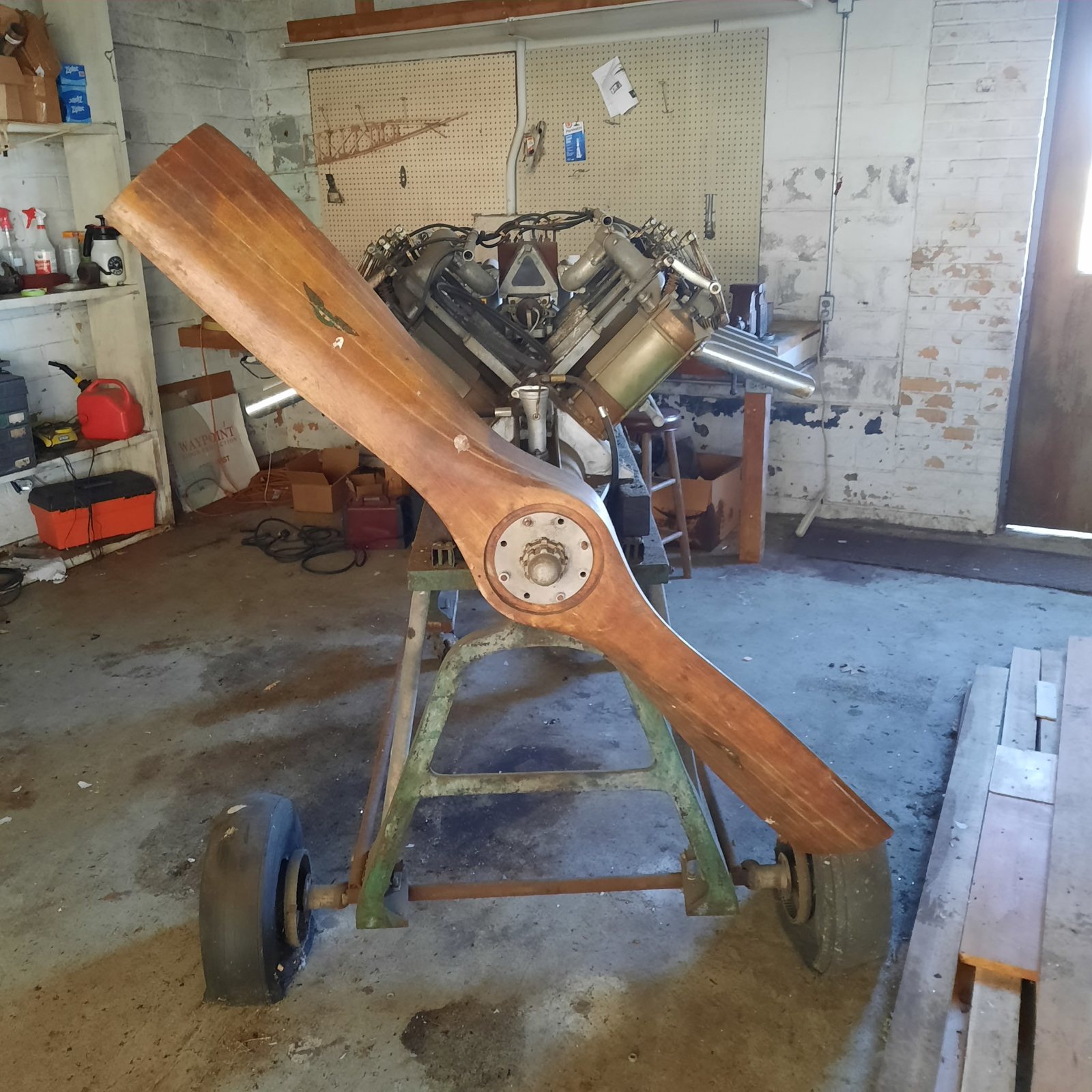 The Curtiss OX-5 that came to the Collection with the Eaglerock, on its stand with a wooden propeller.